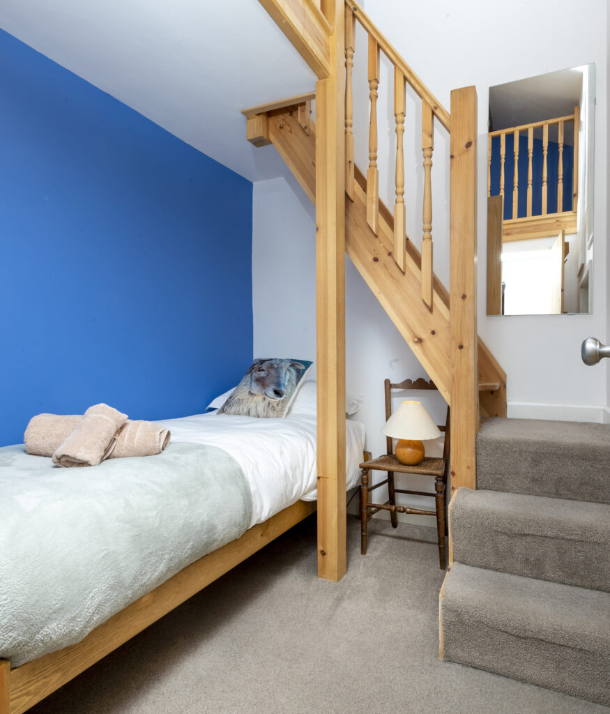 Single bedroom below the mezzanine floor Connecting stairs to top of the house