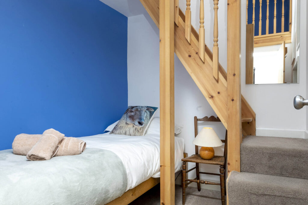 Single bedroom below the mezzanine floor Connecting stairs to top of the house
